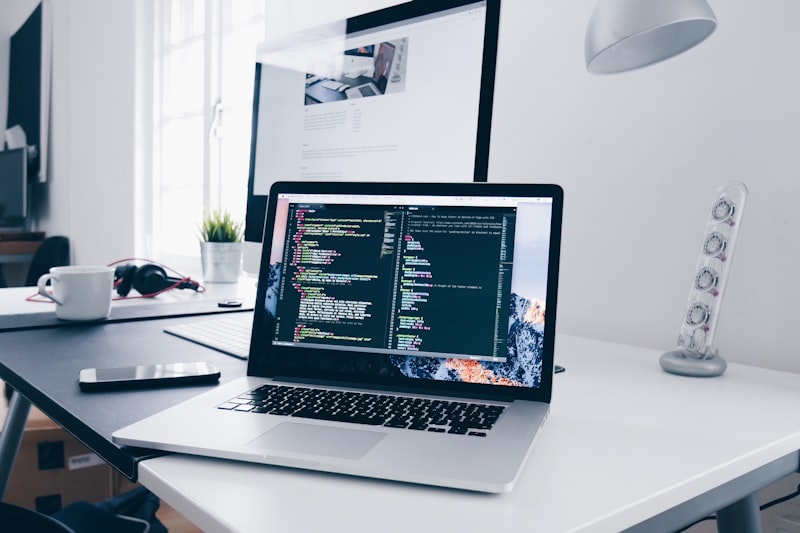 Laptop with code on screen — software development work
